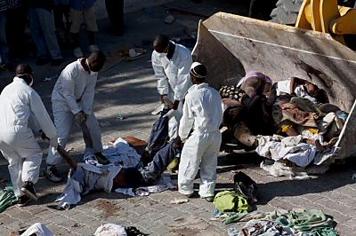 Haitians have resorted to using bulldozers to remove the bodies of earthquake victims - Photo by The Oregonian